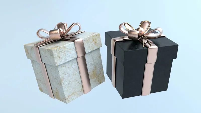 Scatole regalo bianche e nere con fiocchi dorati: luxury packaging e confezioni di pregio
